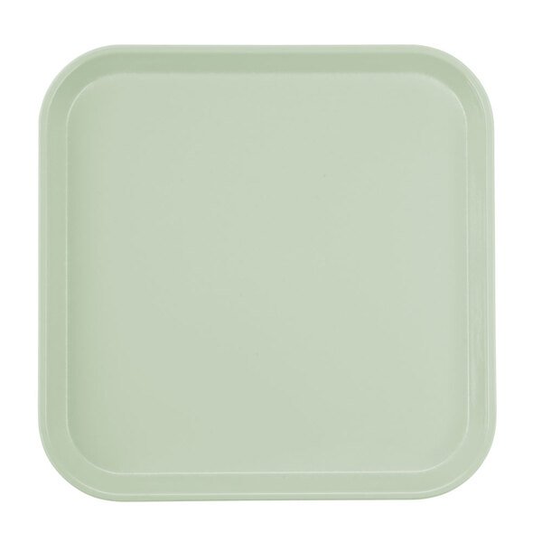 A square white tray with a green border.