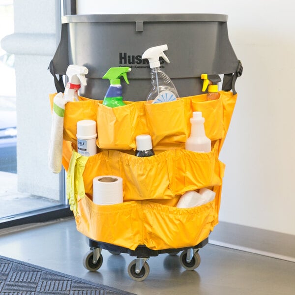 A yellow Lavex caddy bag with cleaning supplies inside.