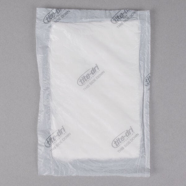 A white plastic bag with a white label reading "White 5" x 7" Absorbent Meat, Fish, and Poultry Pad 75 Grams" containing a white object.