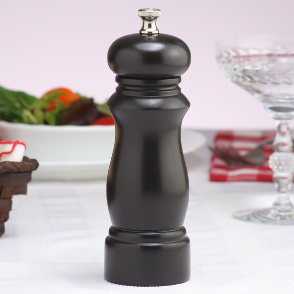 A Chef Specialties Salem Ebony salt mill with black accents on a table.