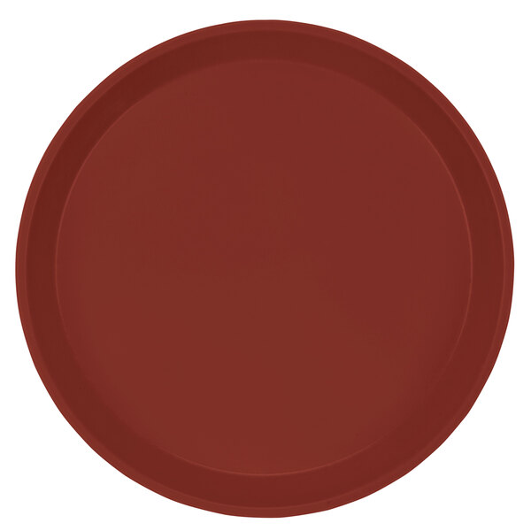 A red round Cambro fiberglass tray with a white border.
