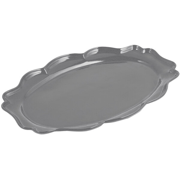 A Bon Chef smoke gray cast aluminum oval platter with a scalloped edge.