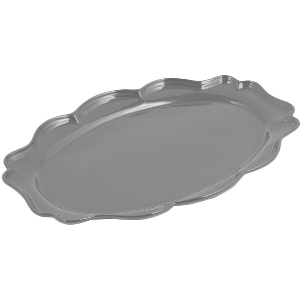 A Bon Chef platinum gray cast aluminum oval platter with a scalloped edge.