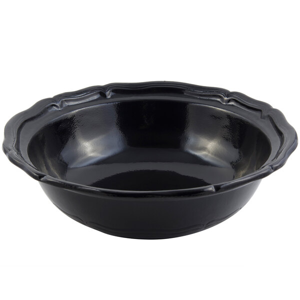 A black Bon Chef cast aluminum salad bowl with a scalloped edge and decorative design.