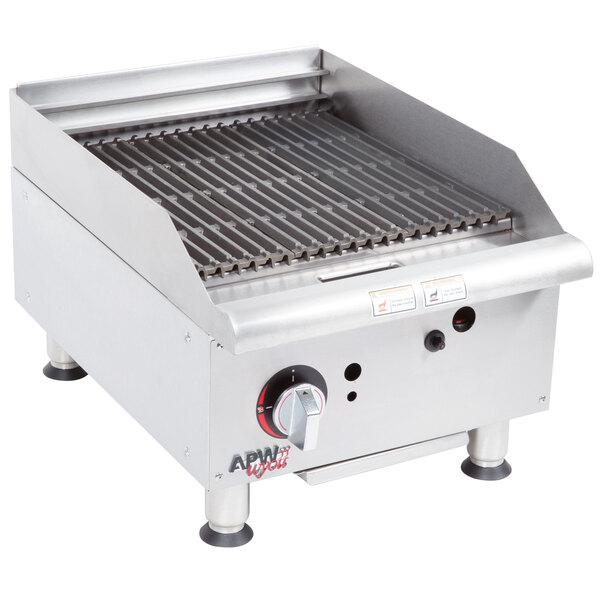 An APW Wyott stainless steel charbroiler with a burner on top.