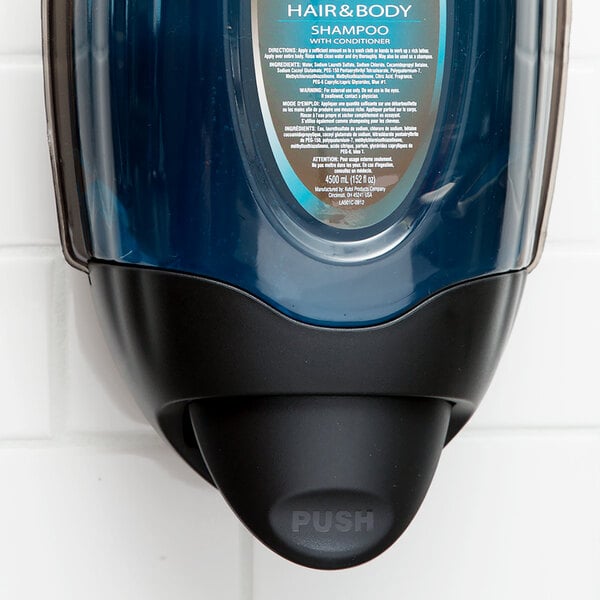 A black Kutol DuraView hand soap dispenser mounted on a white wall.