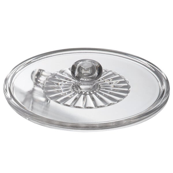 A clear glass lid with a round handle.