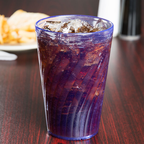 A blue GET plastic tumbler filled with a drink and ice on a table.