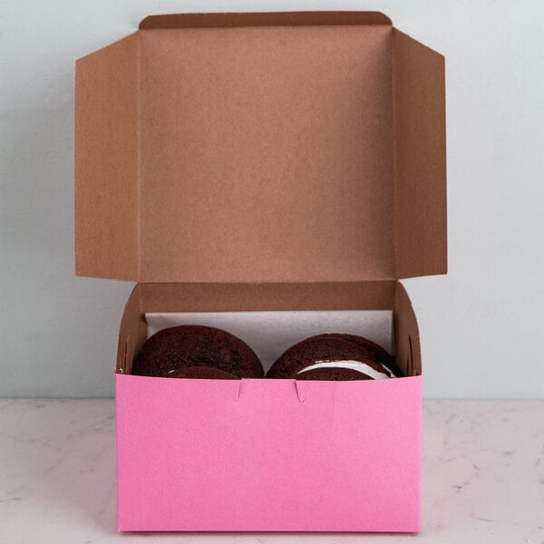 Two donuts in a pink box.