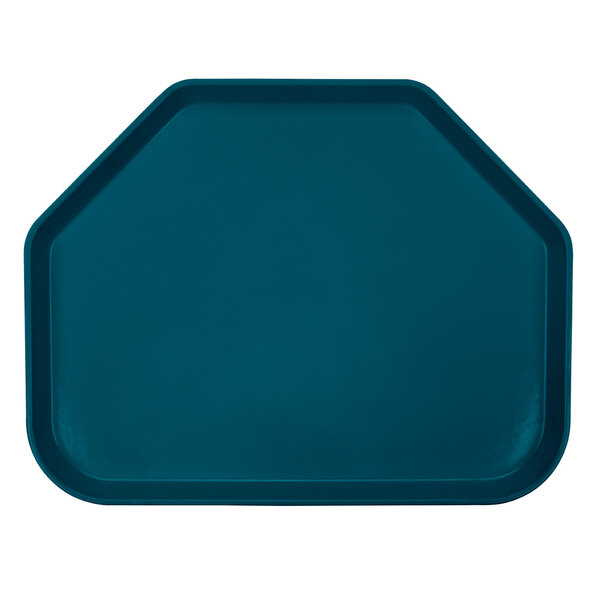 A slate blue trapezoid shaped tray on a table in a school kitchen.
