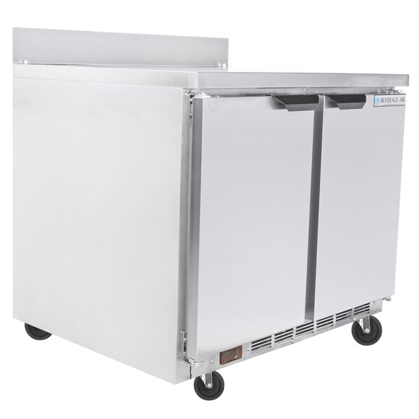 A Beverage-Air stainless steel worktop freezer with two doors on wheels.
