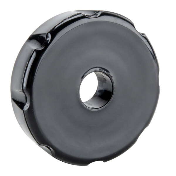 A black circular faucet bonnet with a hole.