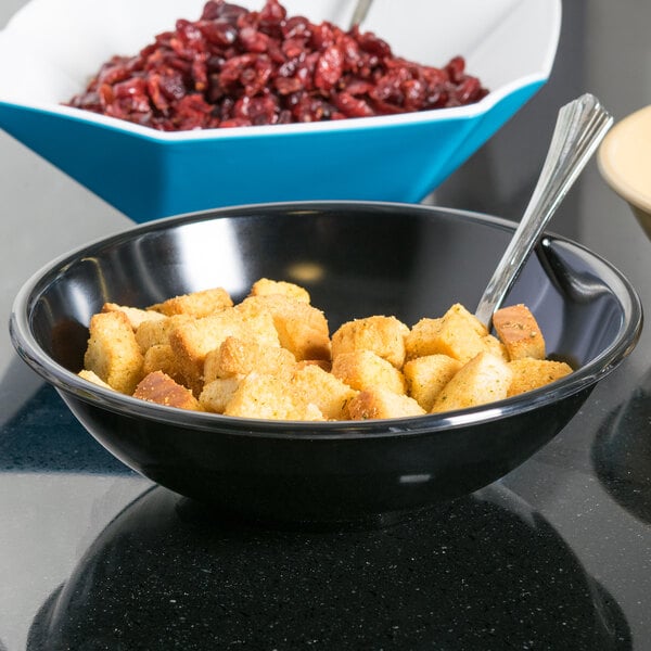 A blue Tablecraft melamine bowl filled with cranberries.