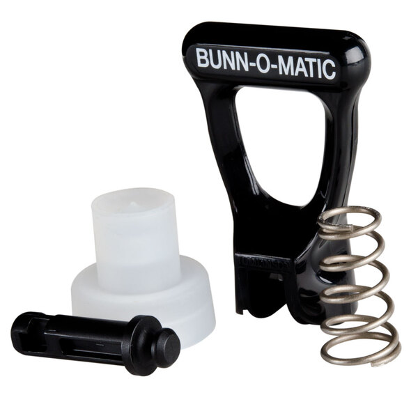 A Bunn faucet repair kit with a black and white device and a spring.