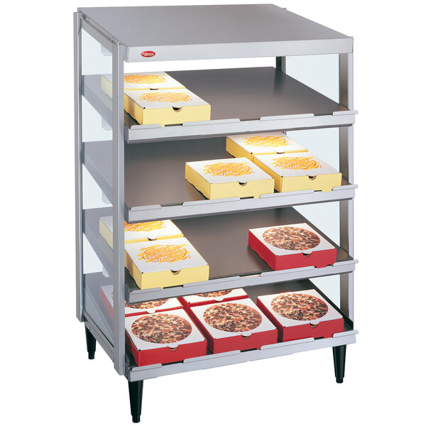 A Hatco countertop pizza warmer with pizzas on shelves.
