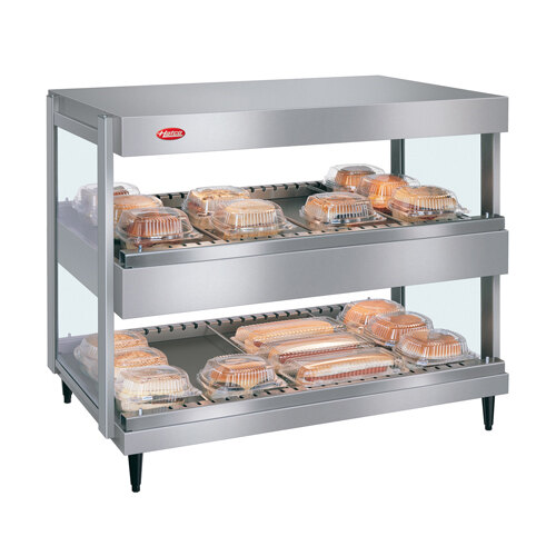 A Hatco countertop merchandiser with food trays on shelves.