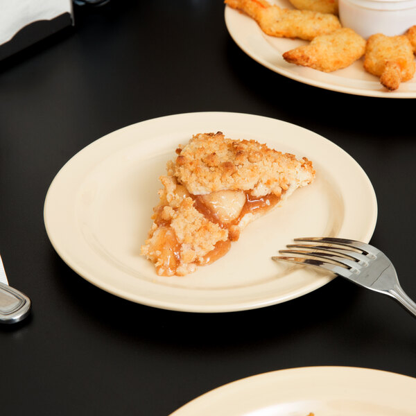 A Thunder Group Nustone Tan melamine plate with a piece of pie and a fork on it.