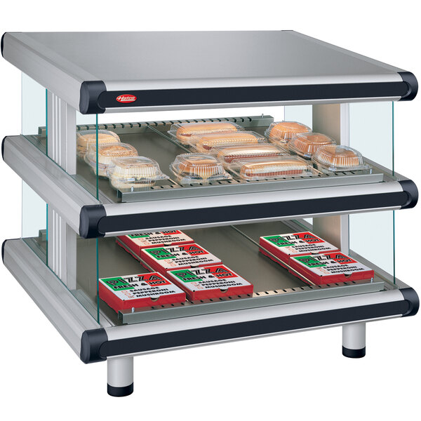 A Hatco countertop display case with food on glass shelves.