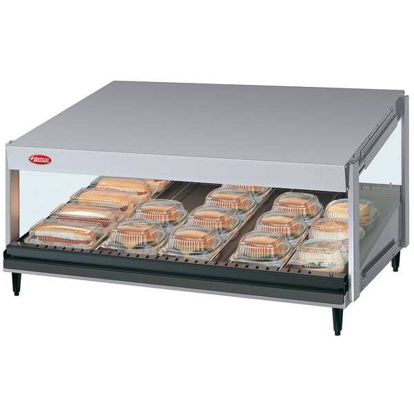 A Hatco countertop hot food display warmer with a tray of sandwiches inside.