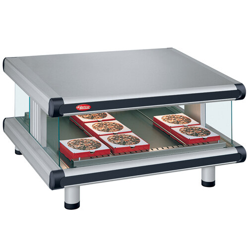 A Hatco countertop food warmer with trays of pizza on it.