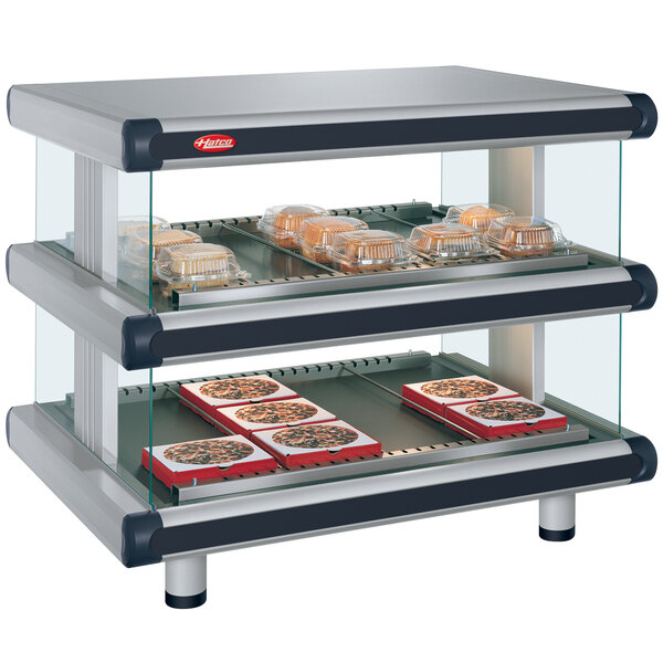 A Hatco countertop merchandiser with food trays in a glass case.