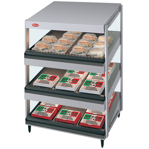 A Hatco slanted triple shelf countertop display case with food on it.