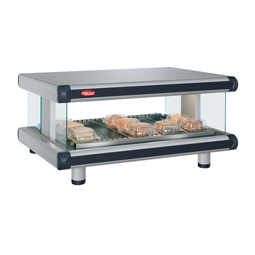 A Hatco countertop hot food display warmer with a tray of food on a glass shelf.