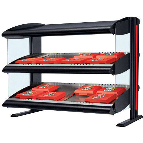 A black Hatco countertop display case with red food trays on a metal shelf.