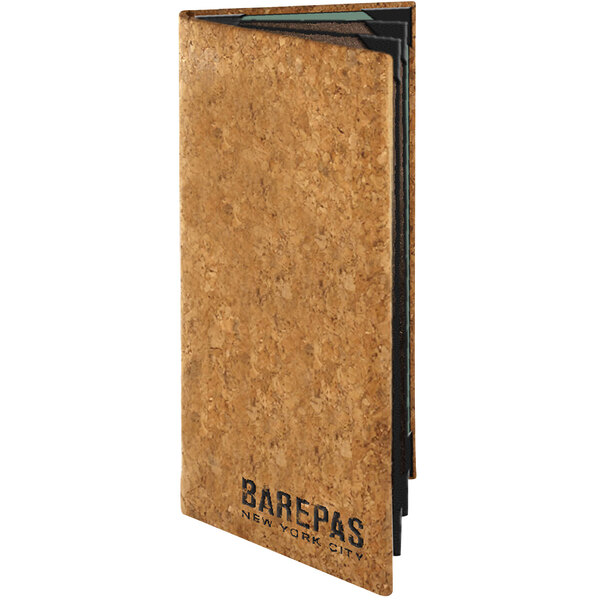 A Menu Solutions customizable natural cork menu cover with black text on it.