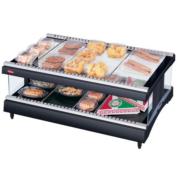 A Hatco countertop heated glass food display case with food on a tray inside.