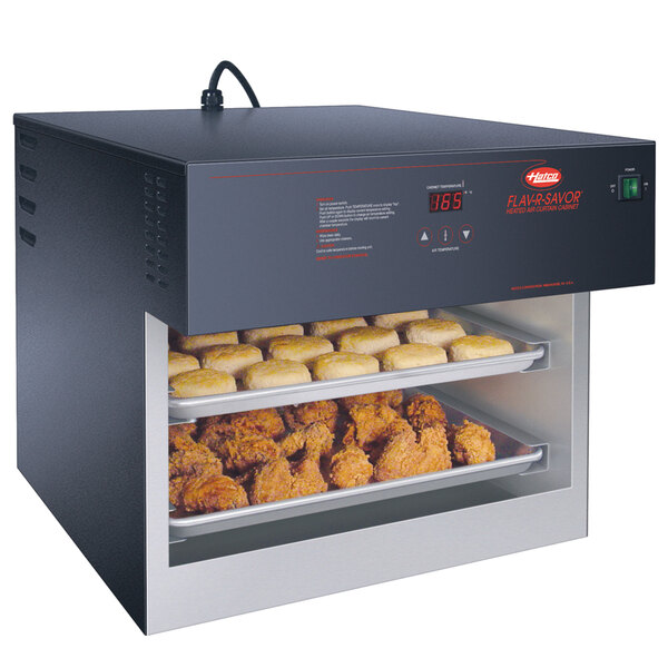 A Hatco Flav-R-Savor heated air curtain holding trays of chicken and biscuits.