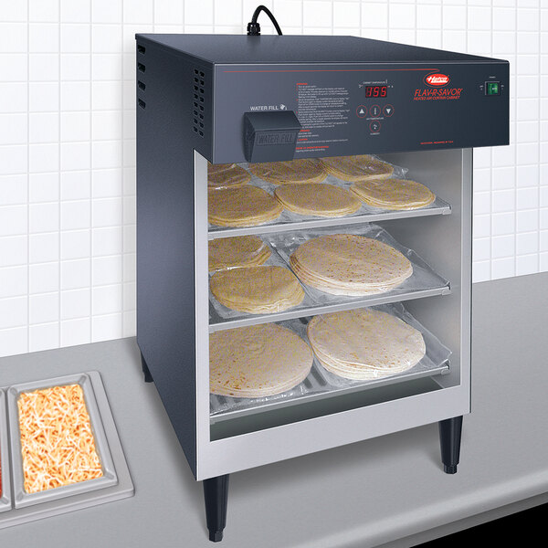A Hatco Flav-R-Savor heated holding bin with tortillas on the shelves.