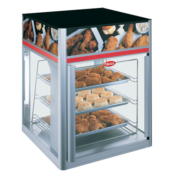 A Hatco Flav-R-Savor display case with chicken and biscuits on a circle rack.