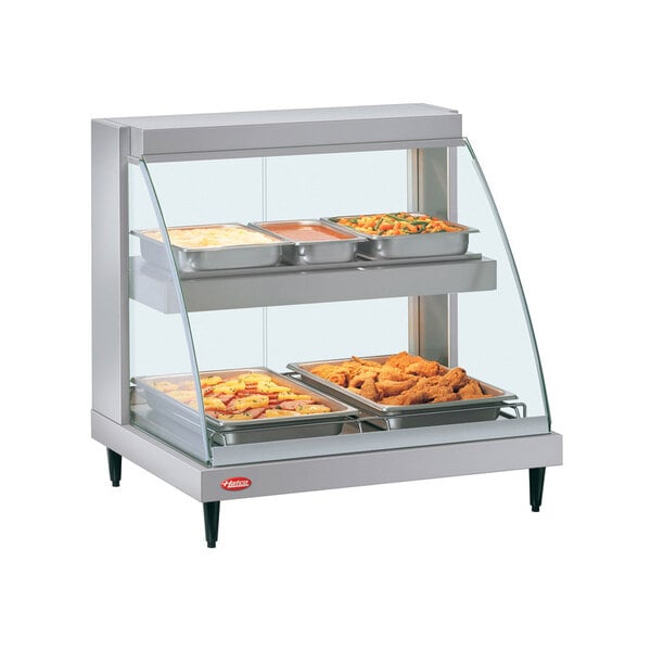 A Hatco Glo-Ray double shelf food display case on a countertop with food in it.