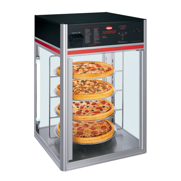 A Hatco Flav-R-Savor pizza display case with pizzas on a tray.