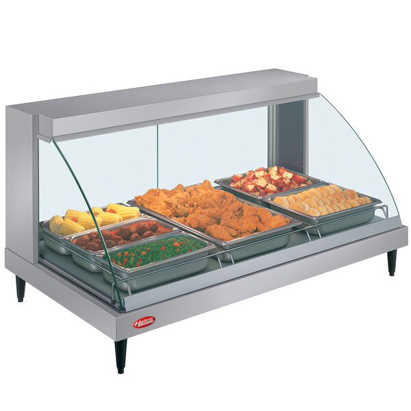 A Hatco countertop display case with food on a shelf.