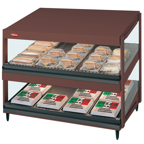 A Hatco Antique Copper slanted double shelf countertop hot food display case with food on trays.