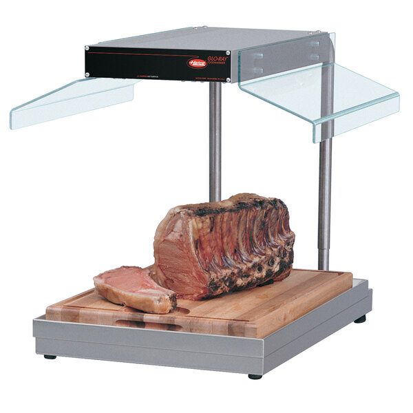 A Hatco carving station with a piece of meat on a cutting board.