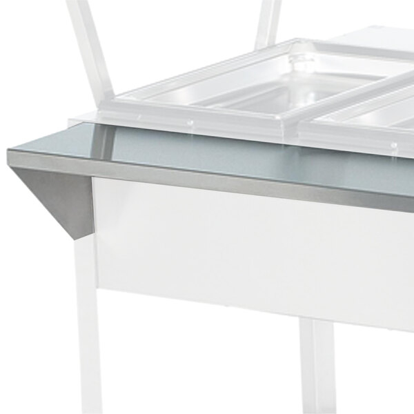 A white and silver rectangular Vollrath plate rest with a clear top over two trays.