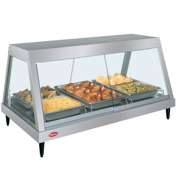 A Hatco stainless steel countertop food display case with food on one shelf.