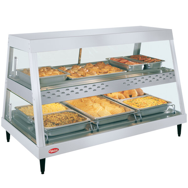 A Hatco white stainless steel countertop display case with food on trays.