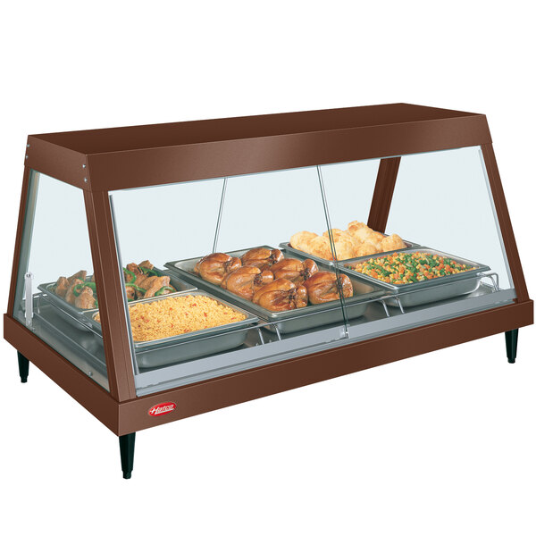 A Hatco countertop hot food display warmer with cooked chicken and vegetables on a tray.