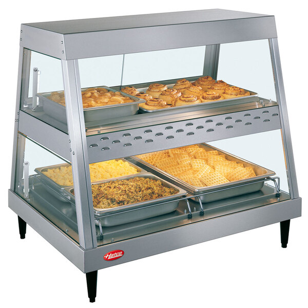 A Hatco countertop food warmer display case with food on trays.