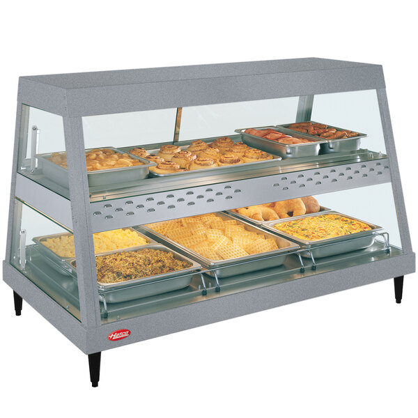 A Hatco countertop food warmer display with trays of food.