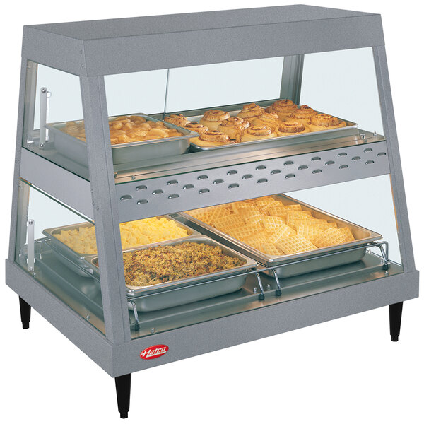 A Hatco countertop food warmer with trays of food on display.