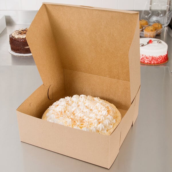 A Kraft cake in a box with red frosting on top.