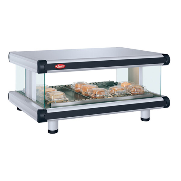 A Hatco Granite Glo-Ray food warmer with trays of food on a shelf.