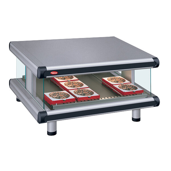A Hatco countertop food warmer with a tray of pizza on it.