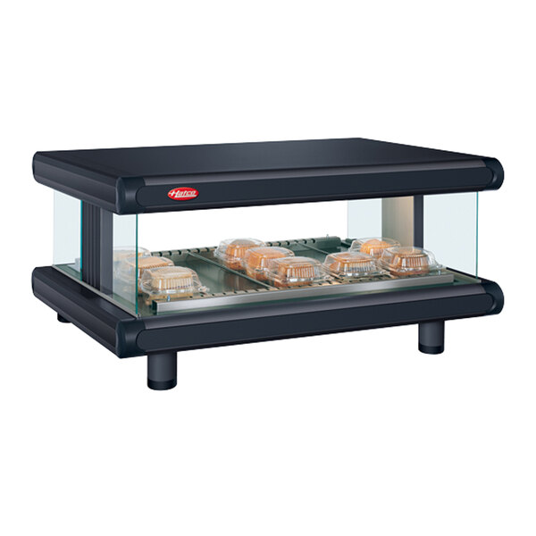 A black Hatco countertop food warmer with clear glass over two trays of food.