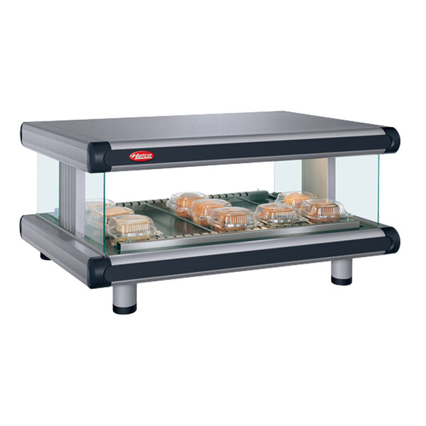 A Hatco countertop display with food trays in a glass case.